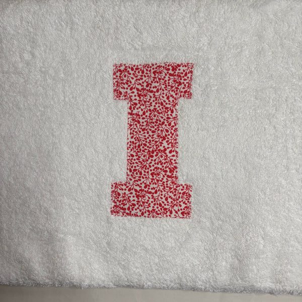 Letter I in red floral fabric appliqued onto a white bath sheet
