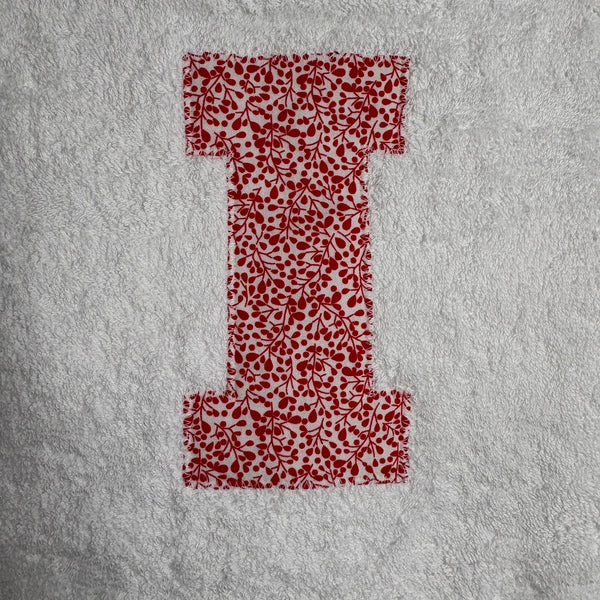 Red Floral patterned letter I appliqued onto a whilte bath sheet