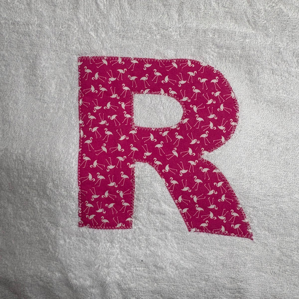 Letter 'R' with flamingo pattern appliqued onto a white jumbo bath sheet 