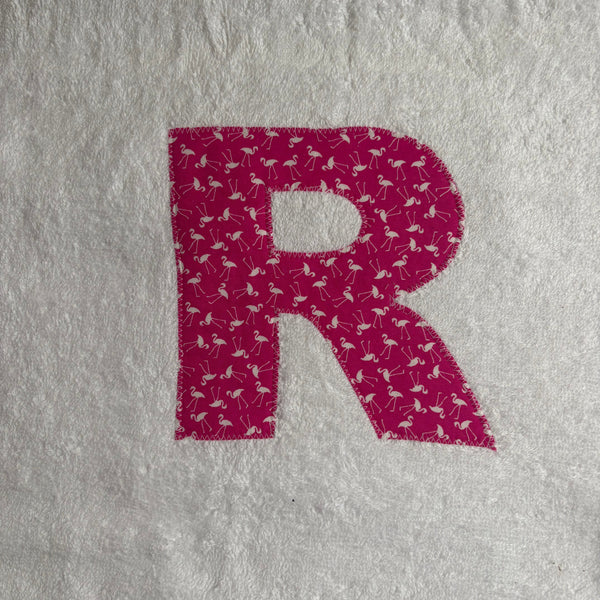 Letter 'R' with flamingo pattern appliqued onto a white jumbo bath sheet 