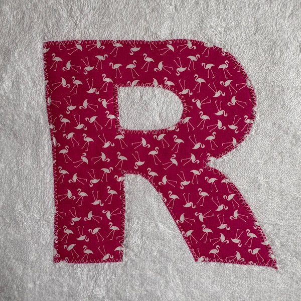 Letter 'R' with flamingo pattern appliqued onto a white jumbo bath sheet 